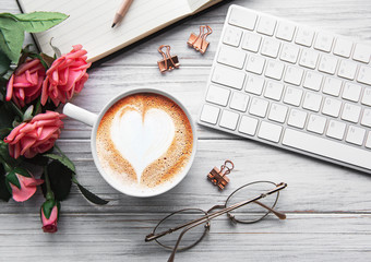 A cup of coffee with heart pattern on a table