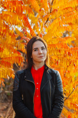 Girl on a background of yellow leaves in autumn.