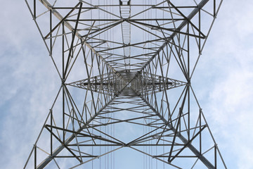 Directly Below Shot Of Electricity Pylon Against Sky