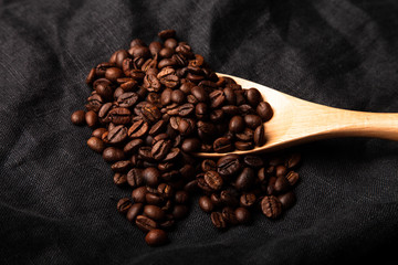 Composition with a coffee beans on a linen napkin for background