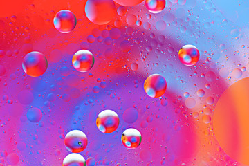 abstract colorful pattern of bubbles from oil drops on water surface