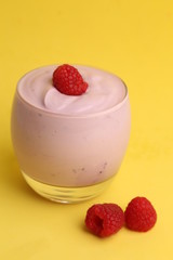 delicious raspberry yogurt in color background