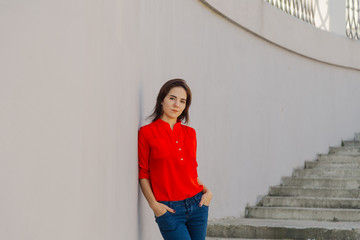Beautiful woman on a concrete staircase. Portrait of a happy woman.
