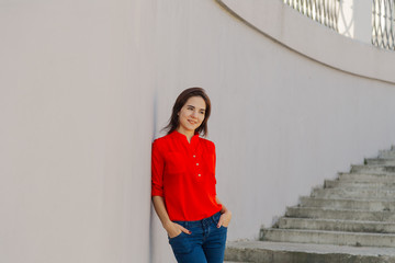 Beautiful woman on a concrete staircase. Portrait of a happy woman.