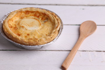 Delicious three cheese quiche in colored background
