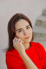 Beautiful woman on a concrete staircase. Portrait of a happy woman.