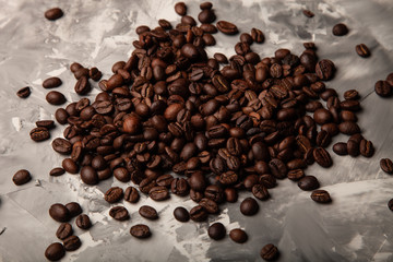 Composition with a coffee beans on a textured plastered background with a variety of arbitrary stains