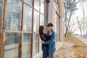 Happy lovers by the window in the park in autumn weather.