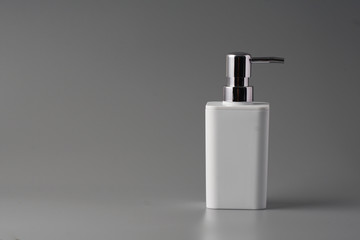 Liquid soap bottle on grey background