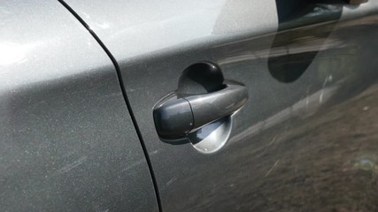 Closing gray car door with hand 4K video