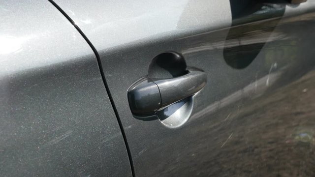 Closing gray car door with hand 4K video