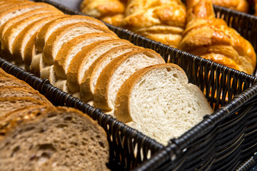Sliced bread and croissants in a basket