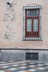 Fototapeta na wymiar Interesting door, wall facade and tile street in Madrid Spain