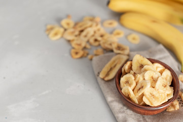 Banana - This is a close up shot of a bowl full of dried banana chips. Shot with a shallow depth of field and vignetting.