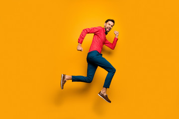 Fototapeta na wymiar Full size profile photo of funny guy jump high up rush black friday shopping center wear trendy red shirt bow tie pants shoes outfit isolated yellow color background