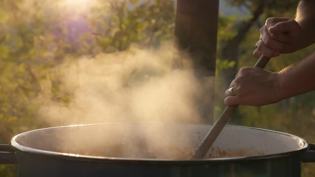 Lot of steam from the cauldron with ajvar mixture slow motion video