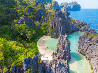 Aerial view of Hidden beach in Matinloc Island, El Nido, Palawan, Philippines - Tour C route - Paradise lagoon and beach in tropical scenery