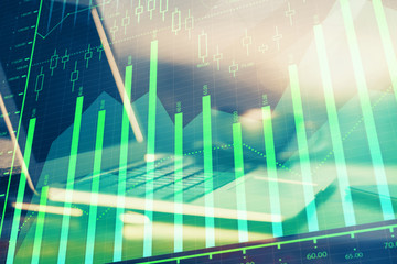 Financial graph colorful drawing and table with computer on background. Multi exposure. Concept of international markets.