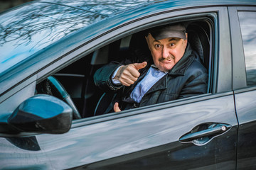 Drunk and crazy senior in automobile. Mature older man lifestyle