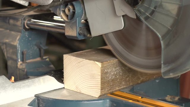 Super Slow motion of wood being sawn / chopped in the workshop. Tools / Machinery - Cutting. Stock Video clip footage.