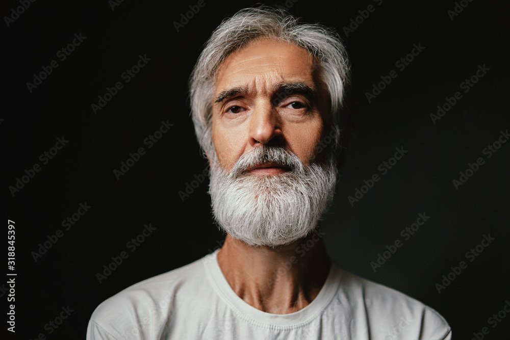 Canvas Prints Studio portrait of frowning senior man with gray beard.