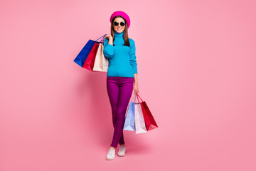 Full length body size view of her she nice-looking attractive lovely cheerful cheery girl fashionista carrying bags spending weekend holiday isolated over pink pastel color background