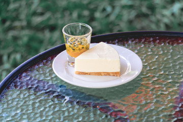 Cake with passion fruit topping on a white plate