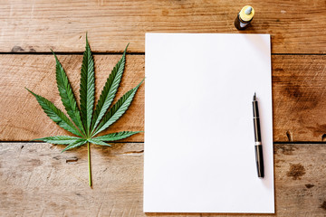 notebook with medical cannabis leaf on table