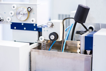 Milling machine tool with mill in chuck preparing to process metal detail at industrial manufacture factory