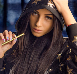 Stylish young woman portrait in sequins hoodie