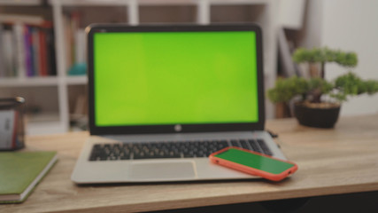 On tablet laptop computer with green screen chroma key display internet business office technology work desk connection keyboard pc device using close up slow motion