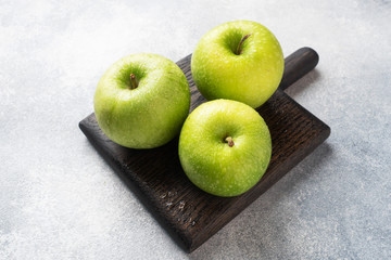 Ripe green apples on a gray concrete background. copy space.