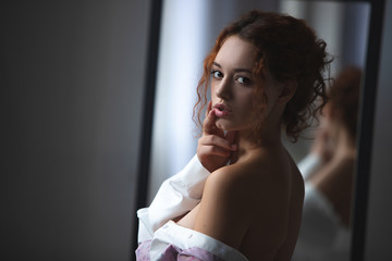 Fototapeta na wymiar Closeup portrait of young beautiful redhaired woman. Redhead female indoors.