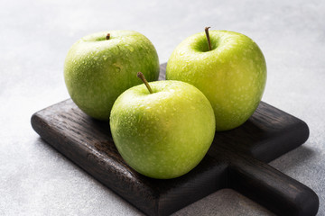 Ripe green apples on a gray concrete background. copy space.