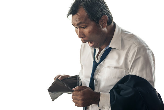 A middle aged Asian business man is shocked by his empty wallet.On isolated white background.