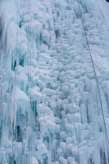 Fototapeta na wymiar Track for winter climbing. Ice wall with safety ropes.