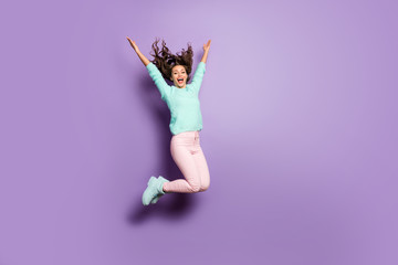 Full length photo of funky lady jump high up good mood rejoicing throwing hairstyle flying weekend wear fuzzy sweater pink pastel pants footwear isolated purple color background