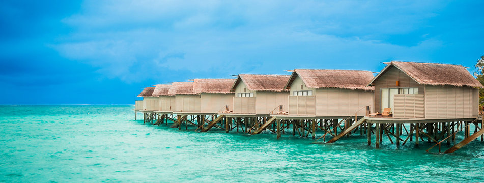 Beautiful view of water bungalow over tropical beach