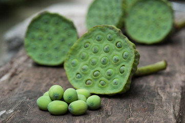 Lotus seed or lotus nut. The traditional Chinese and Indian medicine. Good for healty and can eat both fresh and dried seed as a snack or cooking as a food. Shooting on vintage wood surface table.
