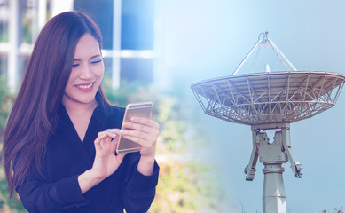 Woman using Mobile phone satellite receiver on background for modern 5G communication and internet...