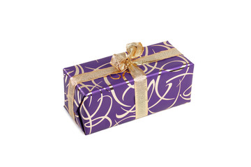 packaged rectangular gift in purple packaging with gold bow and gold pattern on the white background