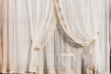 Curtains and tulle in a modern interior. Various decorative fabric materials for the home. Modern...