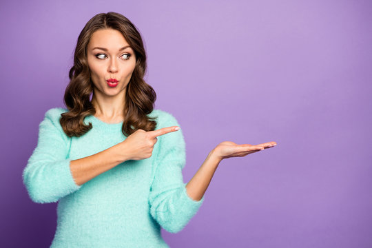 Photo Of Pretty Socked Wavy Lady Hold Open Arm Advising Novelty Product Indicating Finger Cool Low Price Wear Casual Teal Fluffy Sweater Isolated Purple Pastel Color Background