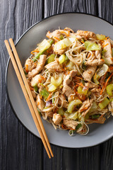 Pancit Bihon Filipino Fried Rice Noodles is a classic  dish that is easy to make with simple ingredients close-up in a plate. Vertical top view