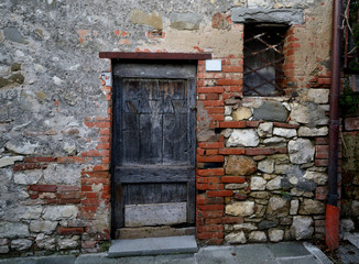 old wooden door in stone wall