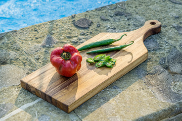 cutting board with knife and pepper