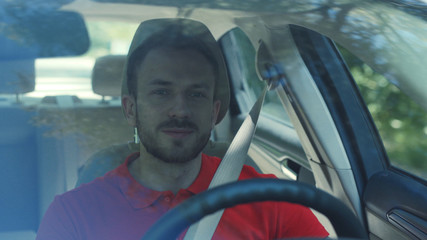 Close up young smiling man driving a car on a road trip sunset sunlight transport holiday happy adventure car short hair free time journey smiling summer travel slow motion