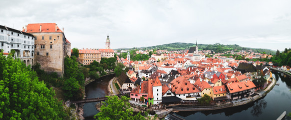 Naklejka na ściany i meble Aerial panoramic view of the typical colorful houses and landmarks of Cesky Krumlov with Vltava river at the foreground (Czech Republic)