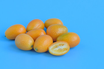 ripe kumquat on a blue background, exotic citrus fruits