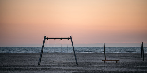 Playground on the beach at sunset